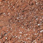 Close-up of #85 Potting Soil Blend, a reddish-brown bulk potting soil with white specks