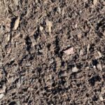 Close-up of Medium Aged Hemlock bark mulch, a dark brown blend of fine bark and small chips