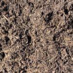 Close-up of Ultralife Compost, a dark brown bulk compost with fine woody fibers