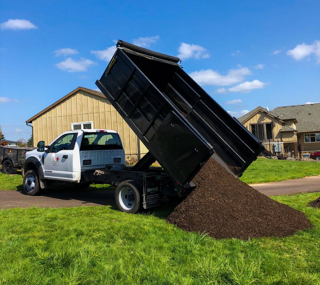 Pro-Gro dump truck delivering a load of soil